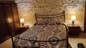 a bedroom with a bed with two lamps on two tables at House Morro di Rasiglia in Rasiglia