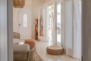 a living room with wicker chairs and a table at Villa Achilleas Crete in Ierapetra +193 photos