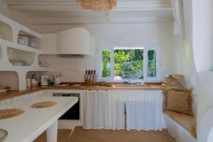 a kitchen with a white counter and a window at Villa Achilleas Crete in Ierapetra