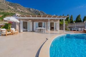 a villa with a swimming pool and a pergola at Villa Achilleas Crete in Ierapetra