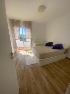 a bedroom with a bed and a large window at Marbella Sunseat apartment in Marbella