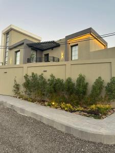 a house with a lot of plants in front of it at Trio Luxury Apartment 3 in Sowayma