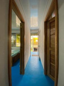 a hallway with two doors and a room with a bed at Ramos de mar in Rincón