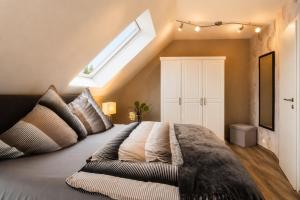 a bedroom with a large bed with a skylight at Lifestyle in Kurort Steinbach-Hallenberg