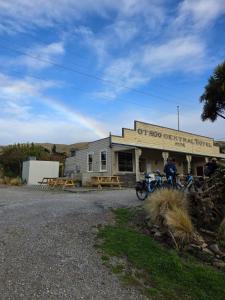a building with two motorcycles parked in front of it at Central Otago Hydeaway in Hyde