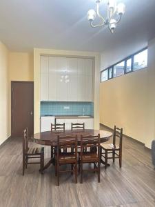 a dining room with a table and some chairs at Kaprovani Sani Villa in Urekis Sadguri +8 photos