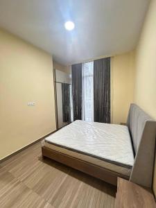 a bedroom with a bed and a large window at Kaprovani Sani Villa in Urekis Sadguri