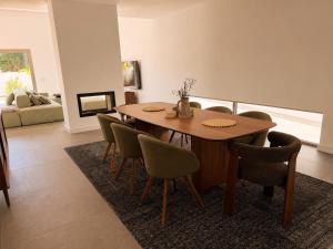 a dining room with a wooden table and chairs at Villa Bazaruto in Lagos