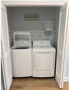 a laundry room with a washer and dryer in it at Wake Up in Wildwood in Wildwood
