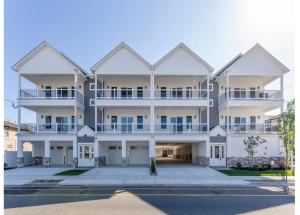 a large white apartment building with a lot of balconies at Wake Up in Wildwood in Wildwood