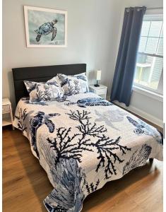a bedroom with a bed with a blue and white blanket at Wake Up in Wildwood in Wildwood +22 photos