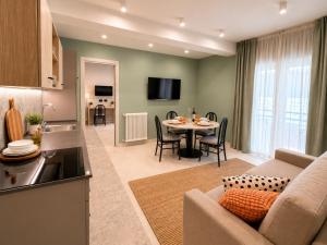 a kitchen and a living room with a couch and a table at Residence Danio in Alassio +32 photos
