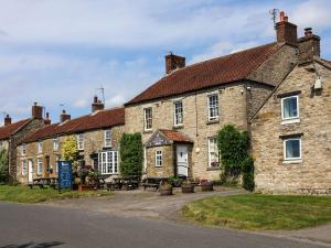 an old stone building with a picnic table in front of it at Granary in Pickering
