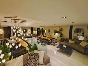 a living room with couches and a dining room at Taj Premium Hotel in Baghdād