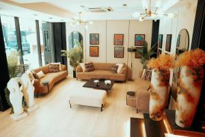 a living room with couches and chairs and tables at Taj Premium Hotel in Baghdād