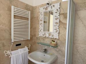 a bathroom with a sink and a mirror and towels at Hotel Bagni Lido in Vada +67 photos