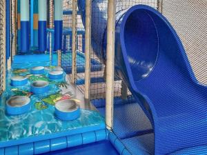 a playground with a blue slide and a blue at Seaside Blue in Ellemeet