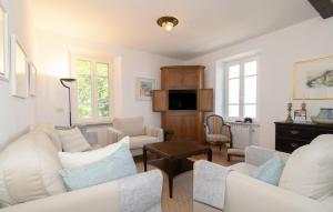 a living room with white furniture and windows at Villa Supina - 3BDR with Pool & Panoramic Lake Garda Views in Toscolano Maderno