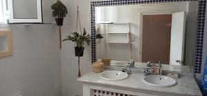 a bathroom with two sinks and a mirror at Espectacular dúplex a pie de mar in Cabo Negro +31 photos