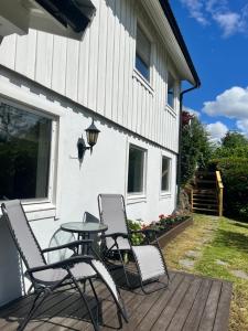 a patio with chairs and a table on a deck at Bright apartment in Haslum in Haslum  +3 photos