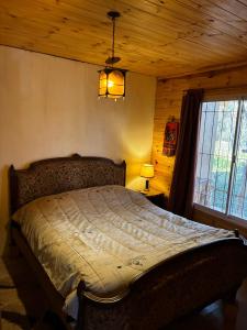 a bedroom with a bed with a wooden ceiling at Rancho Por Fin in Barreal +50 photos