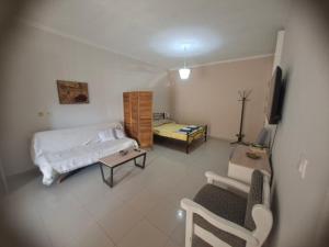 a bedroom with a bed and a tv in it at Chrisa's Home in Salamina