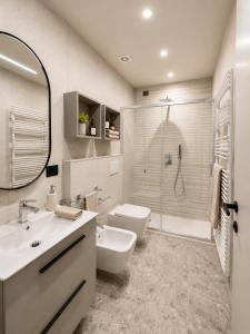 a bathroom with a toilet and a sink and a shower at Residence Danio in Alassio