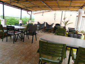 a patio with tables and chairs and a table and chairs at Apartment Valerija in Privlaka