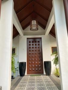a wooden door of a house with a ceiling at The Villa at Mertolas in Alitagtag +18 photos