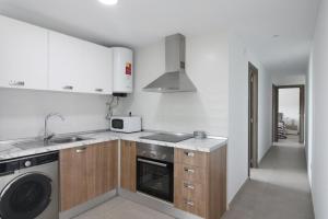 a kitchen with a sink and a dishwasher at La Morada de Sasa Casa tierra in Torrent