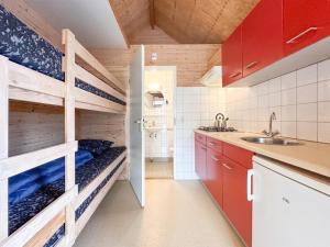 a kitchen with wooden shelves and a sink at Sea Foam in Ellemeet