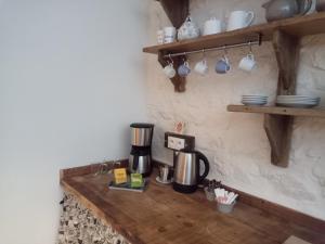 a coffee maker on a wooden counter in a kitchen at La Grange des Lavandes in Mérinchal