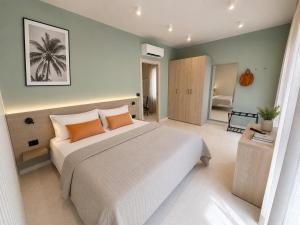 a bedroom with a large bed with orange pillows at Residence Danio in Alassio
