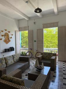 a living room with couches and chairs and a table at Casa 1811 in Cartagena de Indias