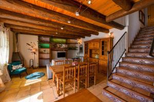 a kitchen and dining room with a table and a staircase at Balcon del Pirineo Rural Ordesa in Buesa