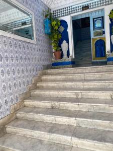 a set of stairs in front of a house at Hôtel Dar Massmoudi in Tunis