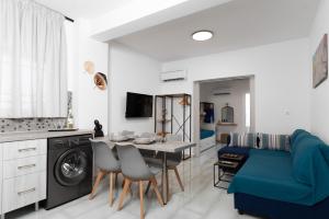 a living room with a blue couch and a table at House of Helios in Pastida