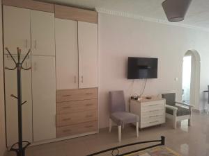 a living room with a dresser and a tv at Chrisa's Home in Salamina +9 photos