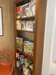 a book shelf filled with cereal and books at Louis Hotel in Perros-Guirec