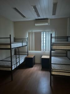 a room with three bunk beds and a window at Residencial Sky Lounge in Lisbon
