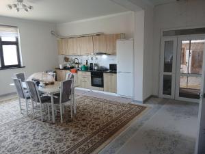 a kitchen with a table and a white refrigerator at Mary's Home in Korumdy