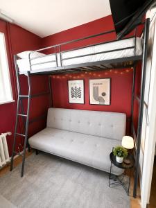 a bedroom with a bunk bed and a ladder at Nyon Red room in Nyon