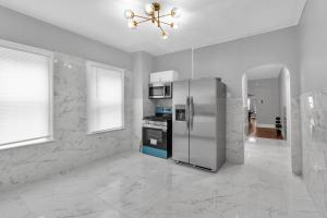 a kitchen with a stainless steel refrigerator and appliances at 5-Bed Home Game Room Pool Table Sleeps 13 in Buffalo