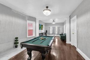 a living room with a pool table in it at 5-Bed Home Game Room Pool Table Sleeps 13 in Buffalo