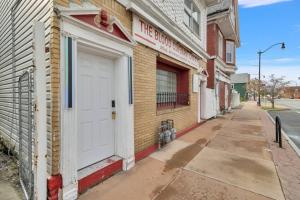 a white door on the side of a building at 5-Bed Home Game Room Pool Table Sleeps 13 in Buffalo