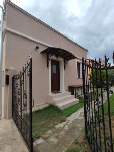 a house with a gate in front of a building at Evita's House in Doxato