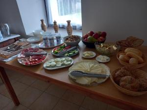 a table with many different types of food on it at Penzion Skřítkův grunt in Struhařov