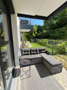 a couch sitting on a patio next to a window at Dolce Vita in Gdynia