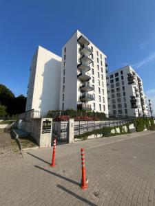 two orange traffic cones in front of a building at Dolce Vita in Gdynia +11 photos