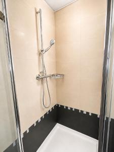 a shower stall in a bathroom with a sink at Alpen Home Room 20 in Kaprun